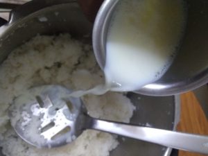 add milk to boiled warm mushed rice 