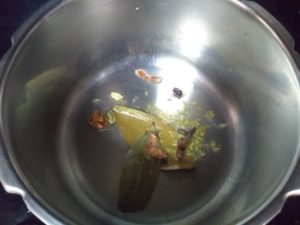 Hyderabad chicken biryani- spices in oil